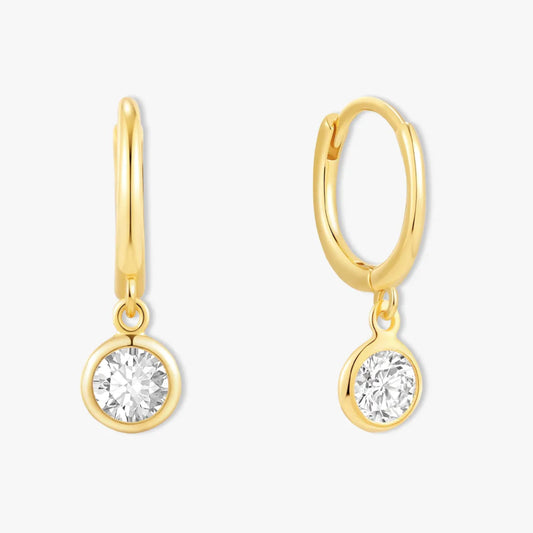 Gold hoop earrings with round gemstones on a white background