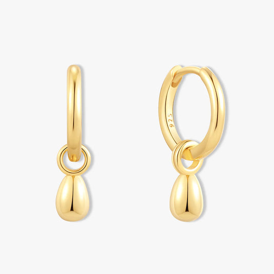 Gold hoop earrings with teardrop pendants on a white background