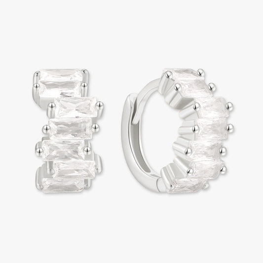 Silver hoop earrings with clear gemstones on a white background