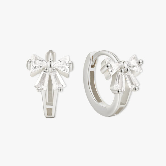 Silver bow-shaped earrings on a white background
