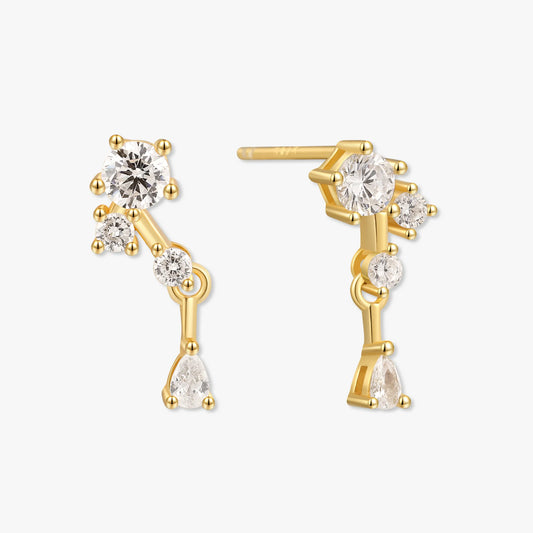 Gold earrings with clear gemstones on a white background