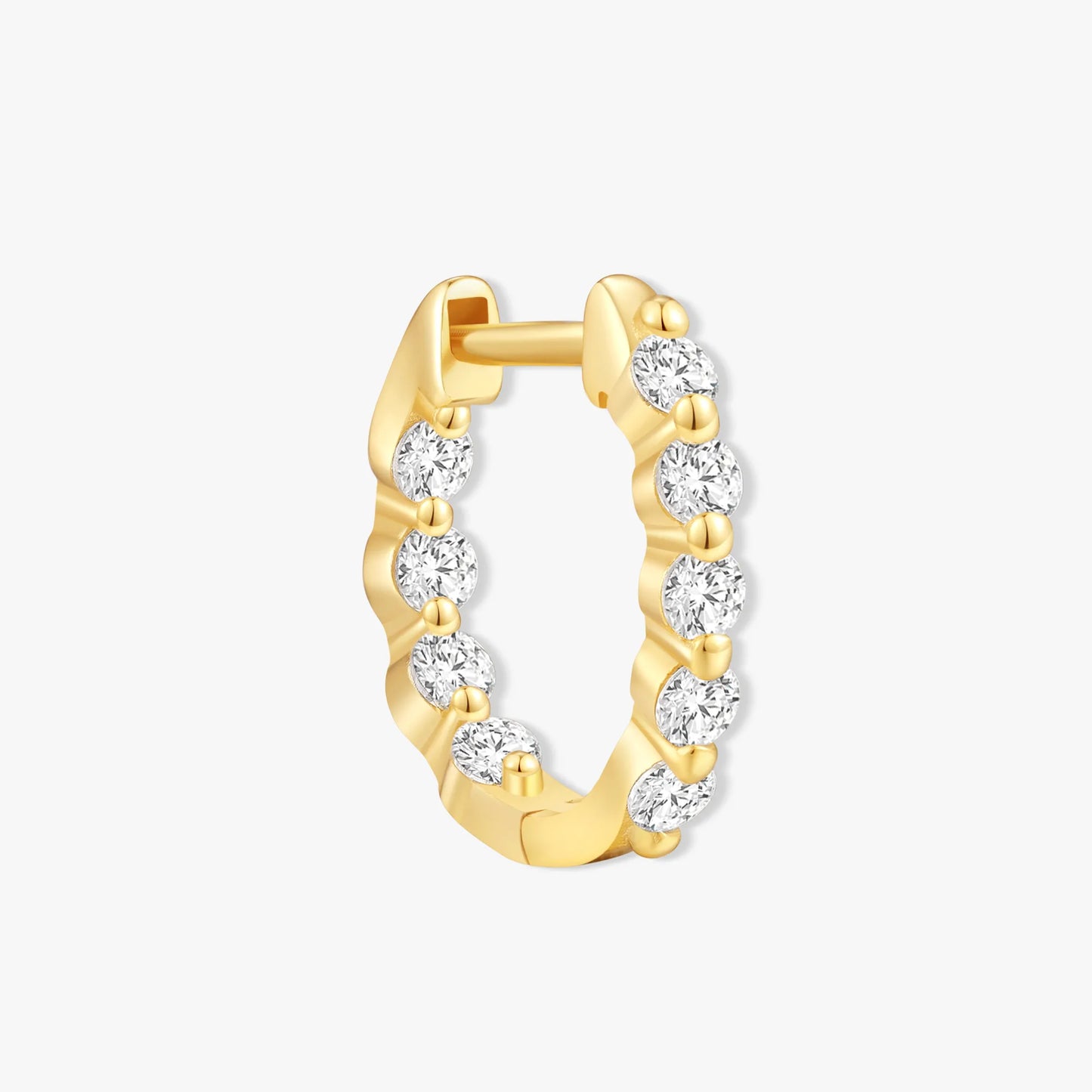 Gold nose ring with embedded diamonds on a white background