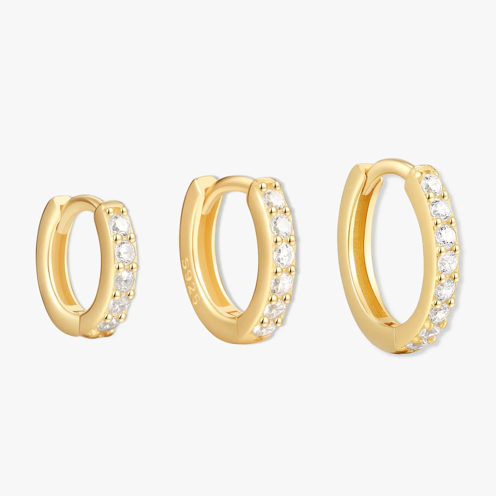 Gold hoop earrings with embedded stones on a white background