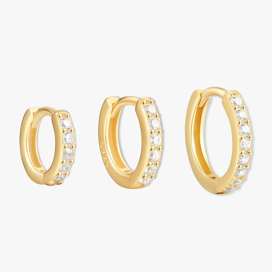 Gold hoop earrings with embedded stones on a white background