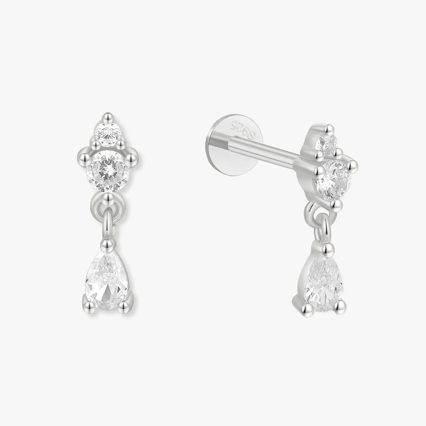 Pair of silver earrings with clear gemstones on a white background