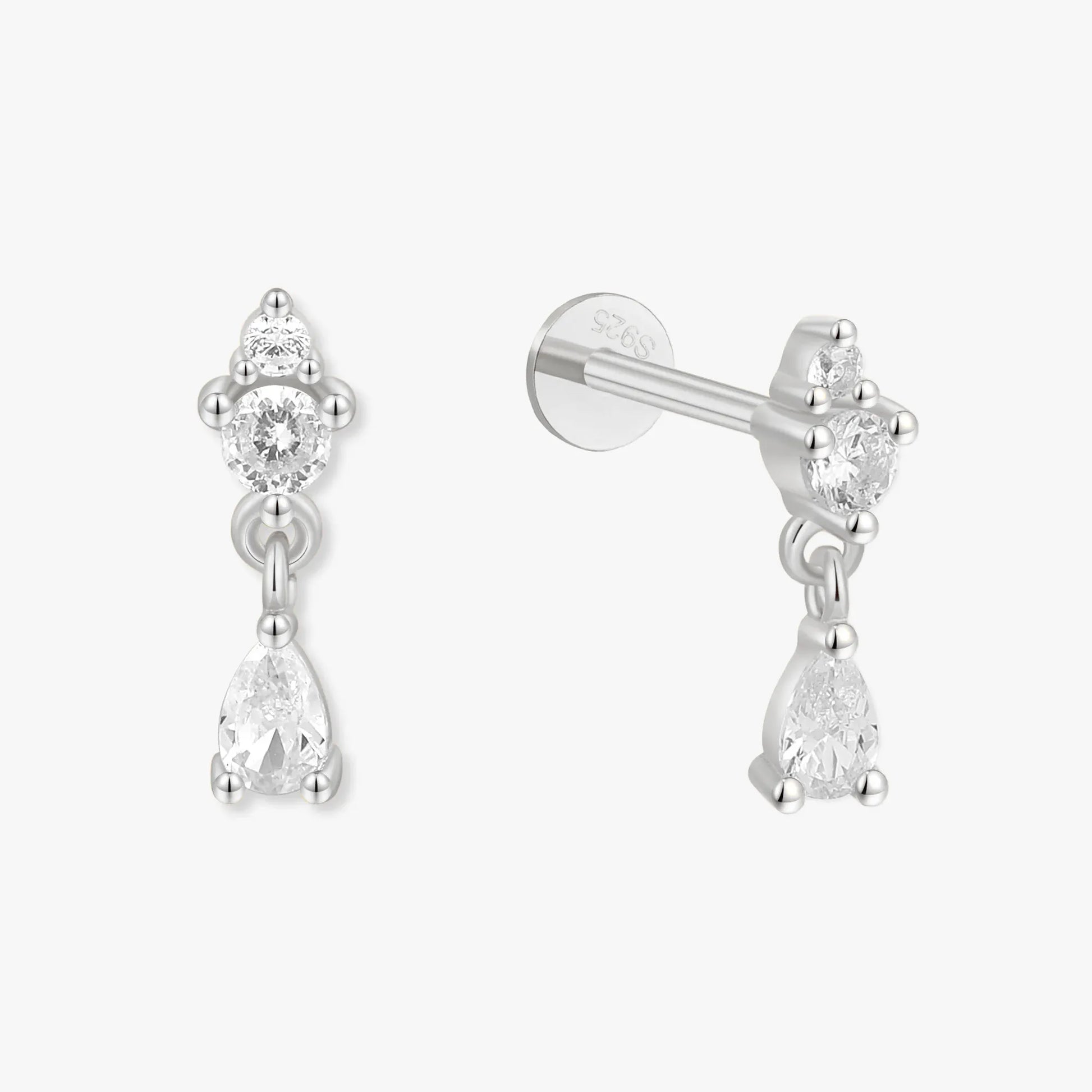 Pair of silver earrings with clear gemstones on a white background