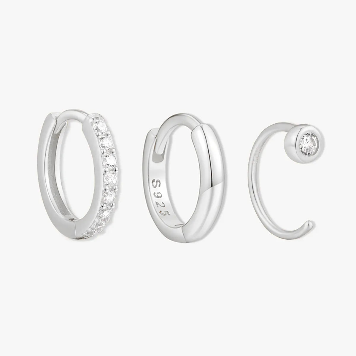 Set of silver hoop earrings on a white background