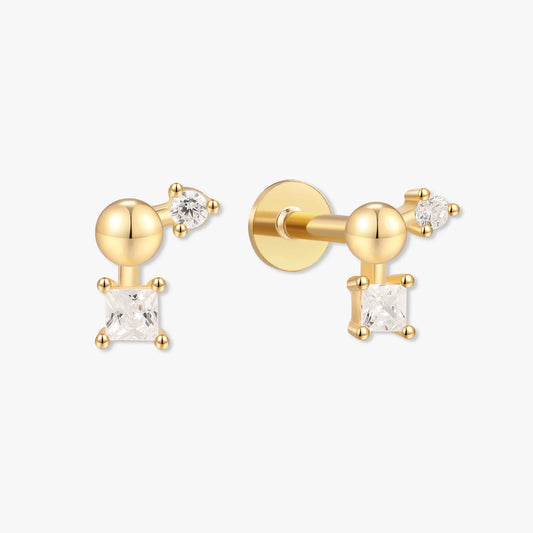 Gold earrings with clear gemstones on a white background