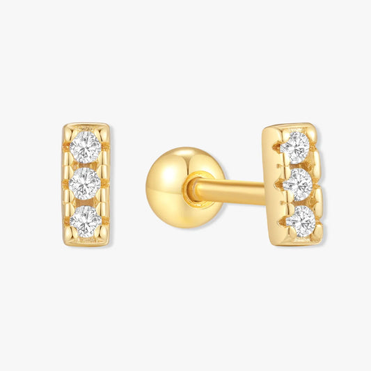 Gold earrings with diamond accents on a white background