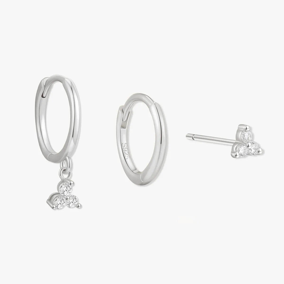 Silver hoop earrings with heart charms on a white background