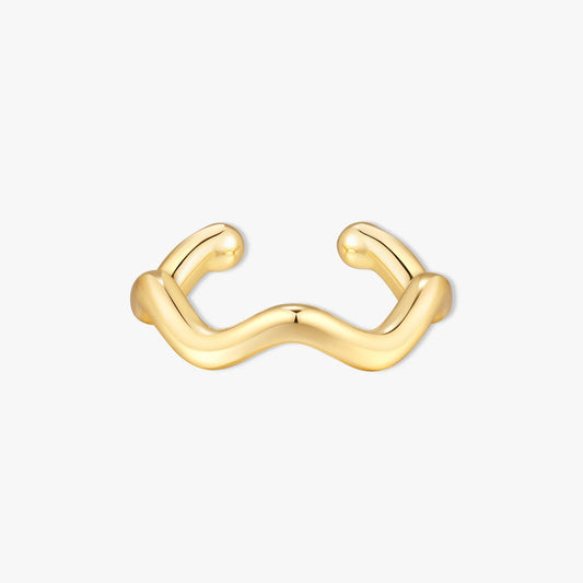 Gold ear cuff with a wavy design on a white background