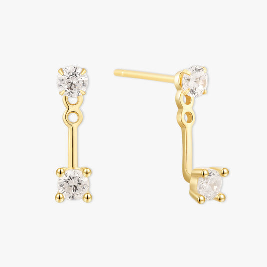 Gold earrings with clear gemstones on a white background