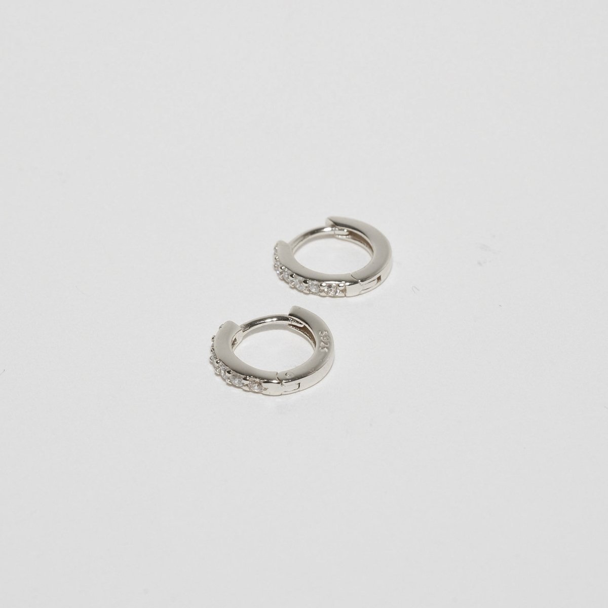 Crystal Paved Huggie Hoops In Silver - LÉA
