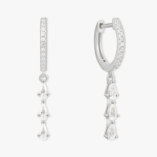 Silver hoop earrings with teardrop-shaped gemstones on a white background