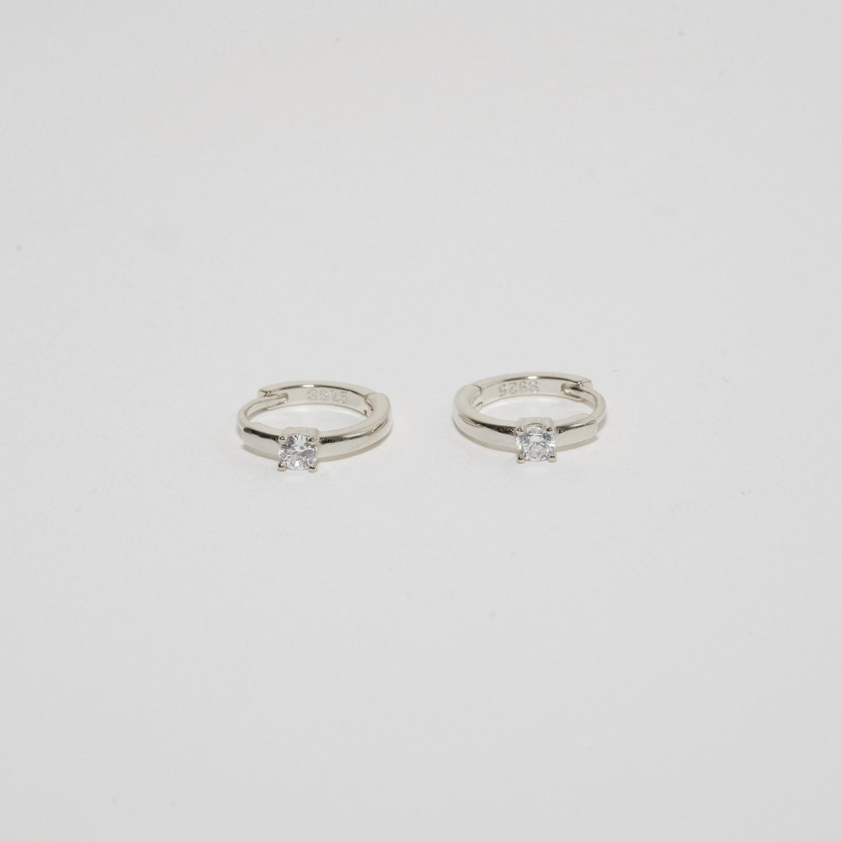 Solitaire Crystal Huggie Hoops In Silver - LÉA