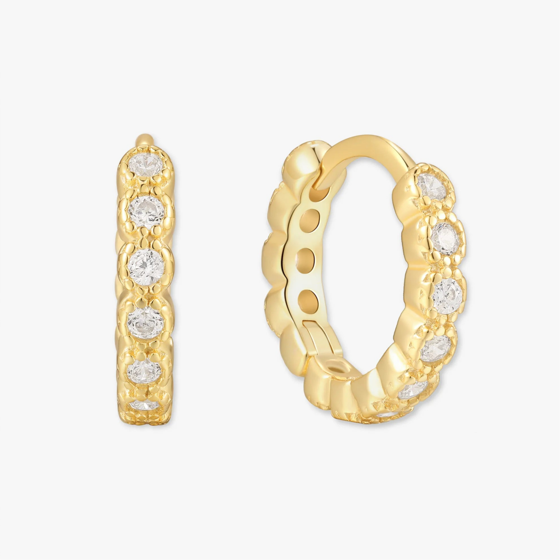 Gold hoop earrings with embedded diamonds on a white background
