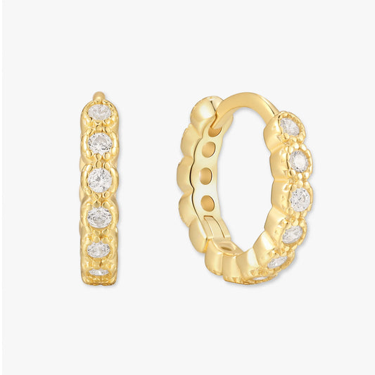 Gold hoop earrings with embedded diamonds on a white background