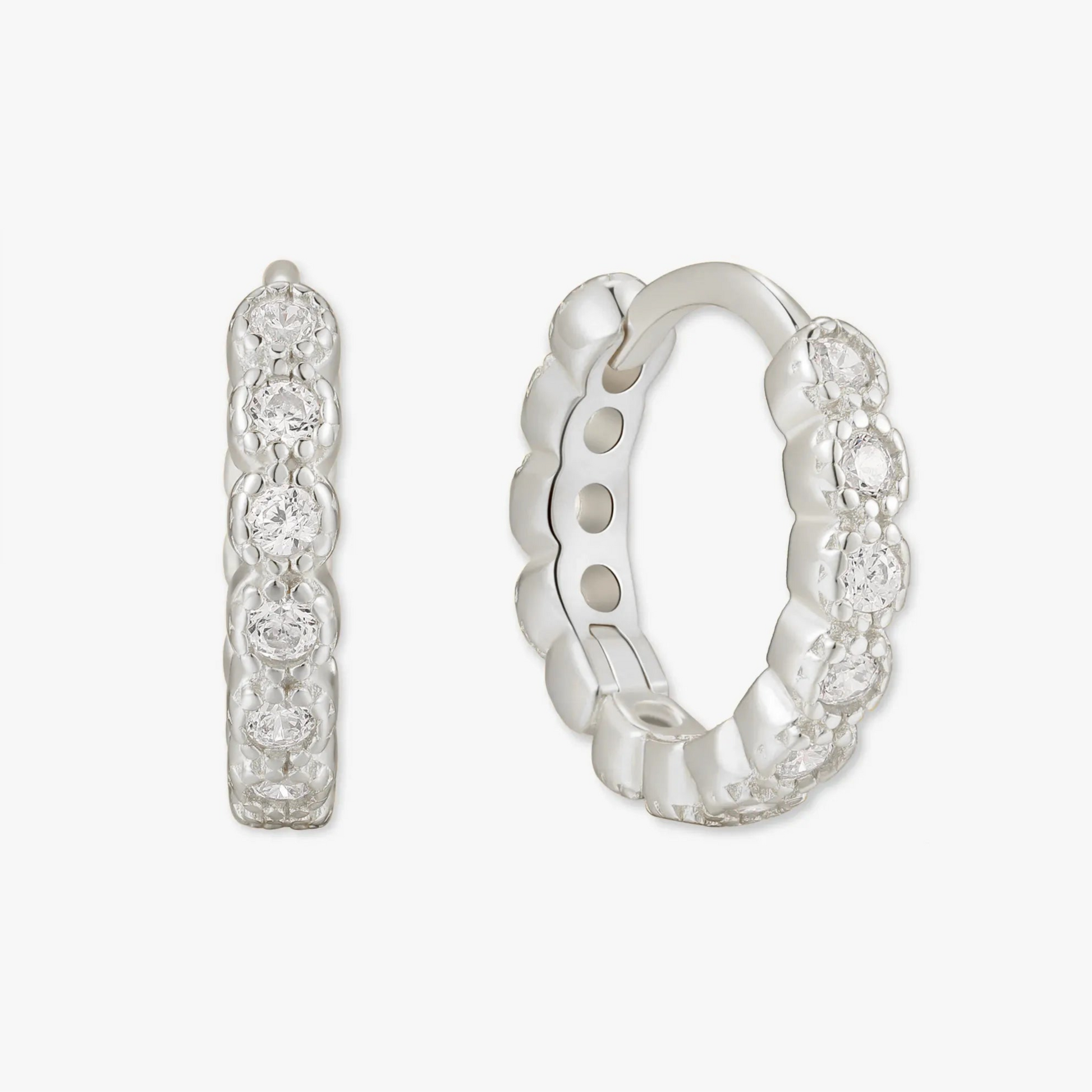 Silver hoop earrings with small diamonds on a white background