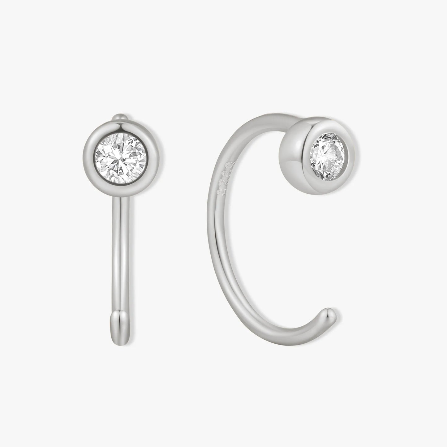 Silver ear cuff with clear gemstones on a white background