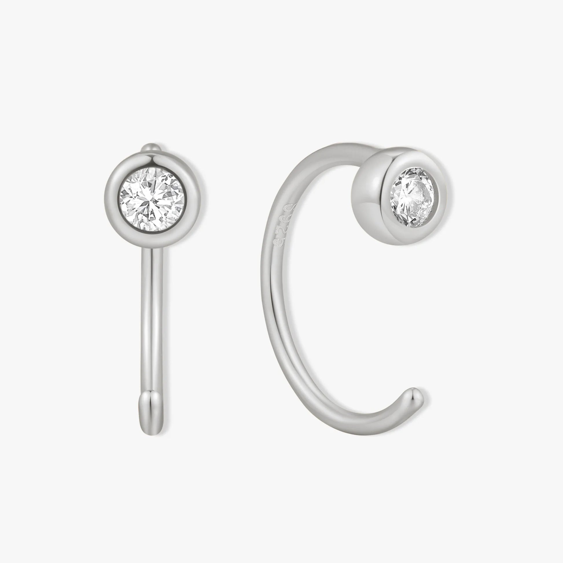 Silver ear cuff with clear gemstones on a white background