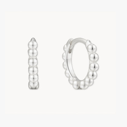 Silver hoop earrings with a bubble design on a white background