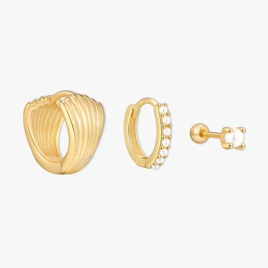 Three gold earrings on a white background