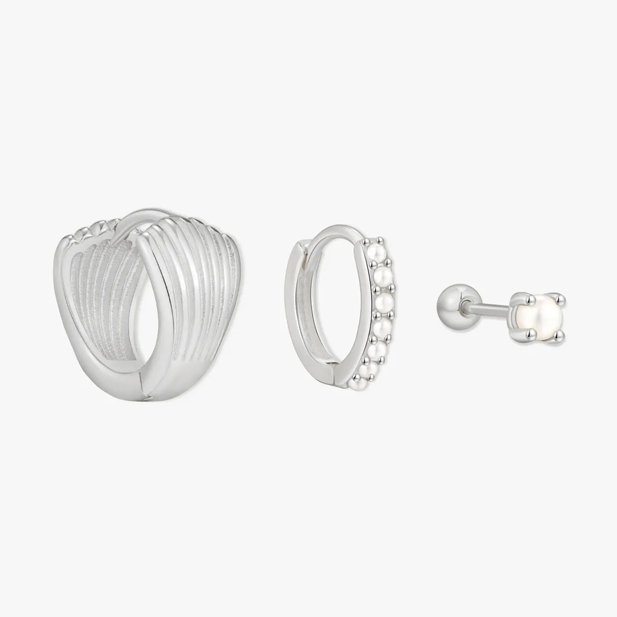 Set of silver earrings on a white background