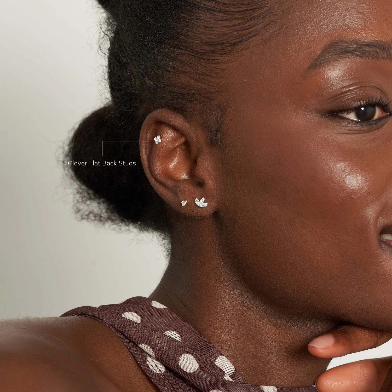 Close-up of a woman wearing earrings with a neutral background