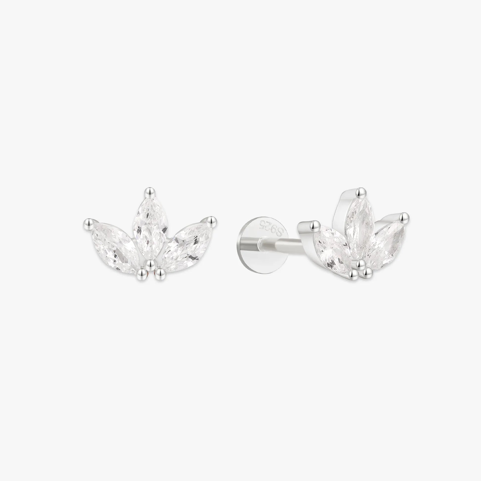 Pair of silver earrings with clear gemstones on a white background