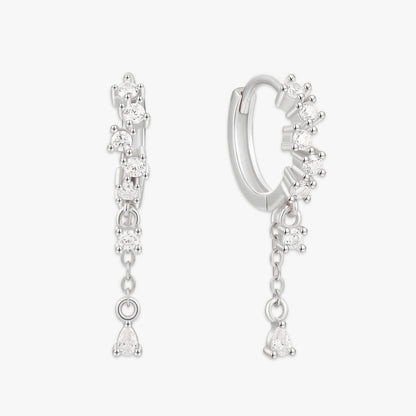 Silver hoop earrings with dangling gemstones on a white background