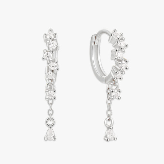 Silver hoop earrings with dangling gemstones on a white background