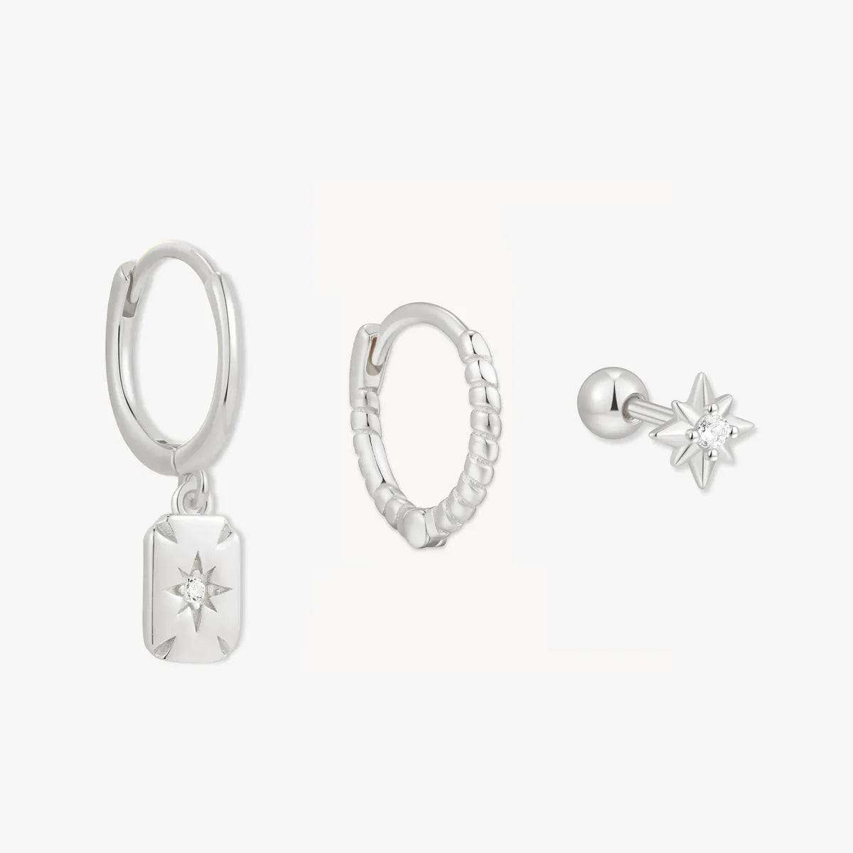 Set of silver earrings on a white background