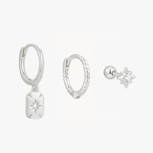 Set of silver earrings on a white background