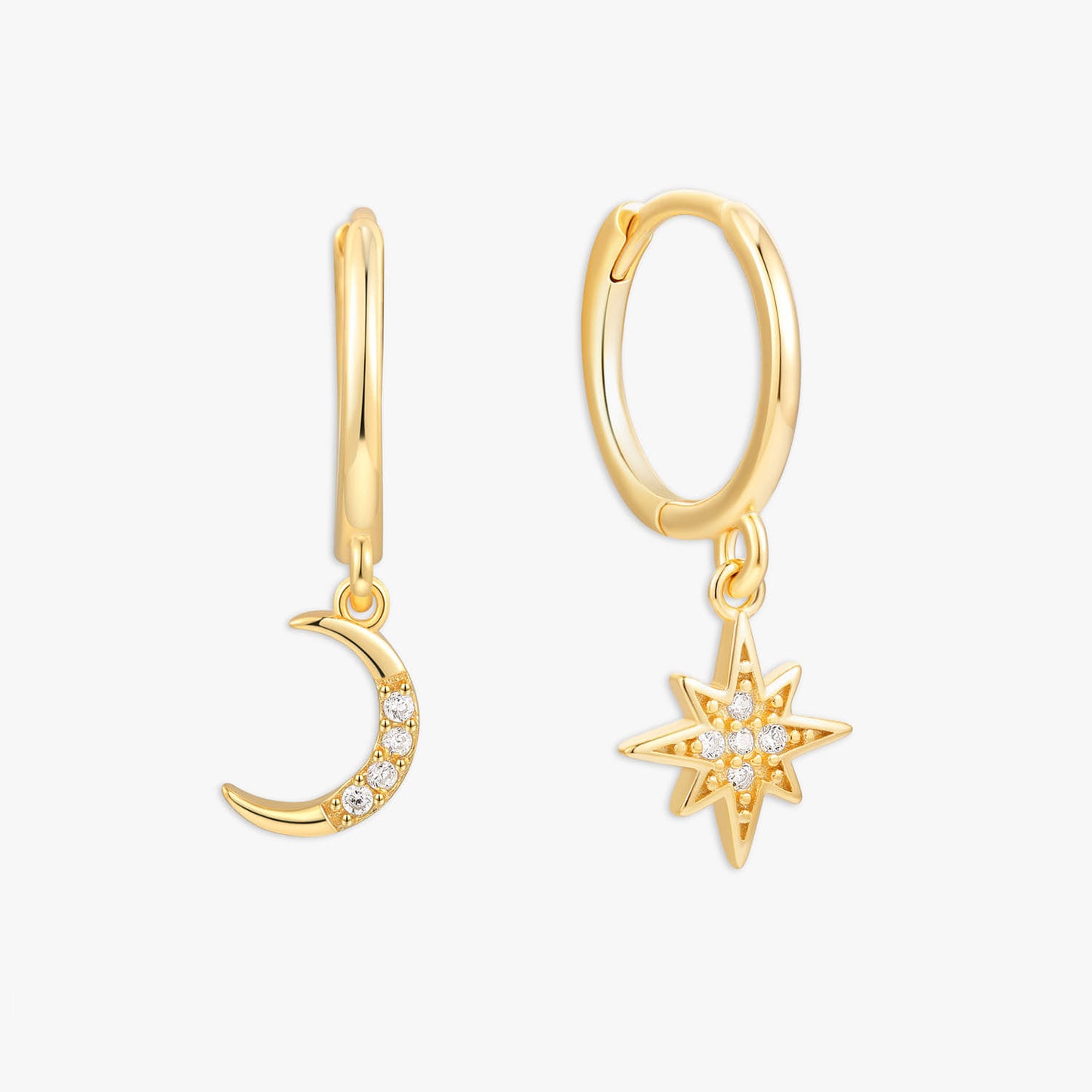 Gold hoop earrings with moon and star charms on a white background