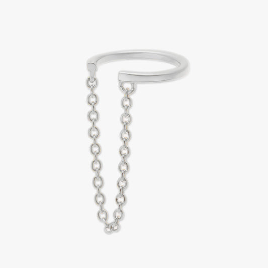 Silver ear cuff with a chain extension on a light gray background