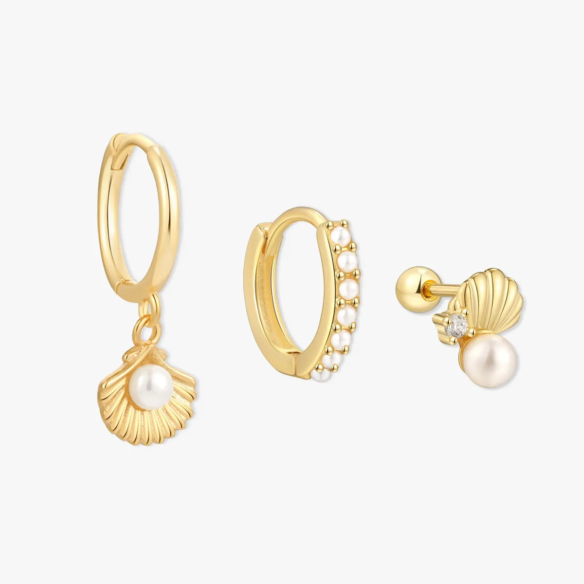Gold hoop earrings with pearl charms on a white background
