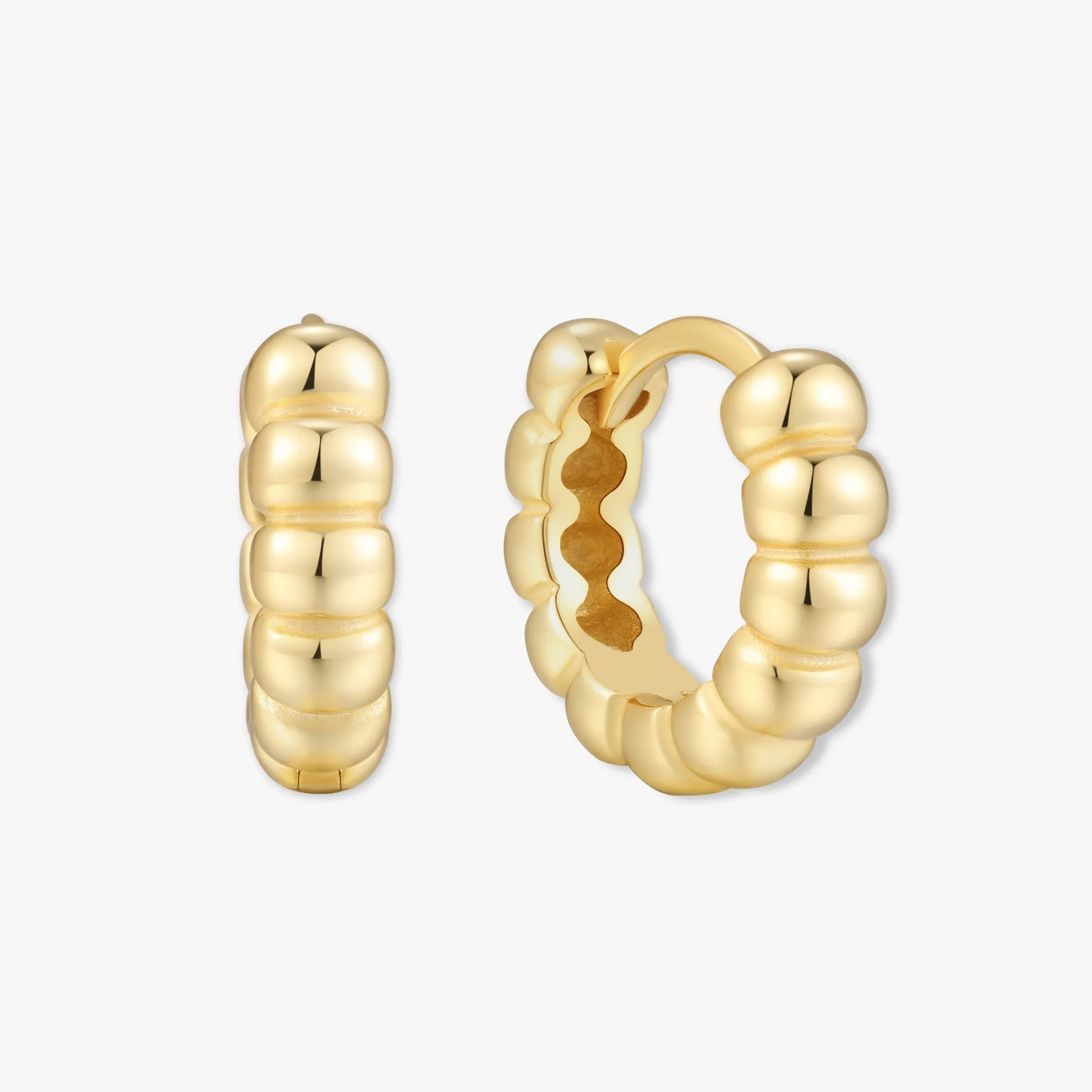 Gold hoop earrings on a white background