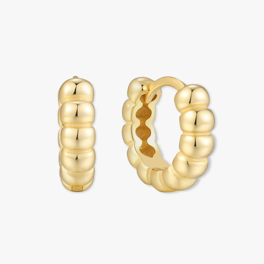 Gold hoop earrings on a white background