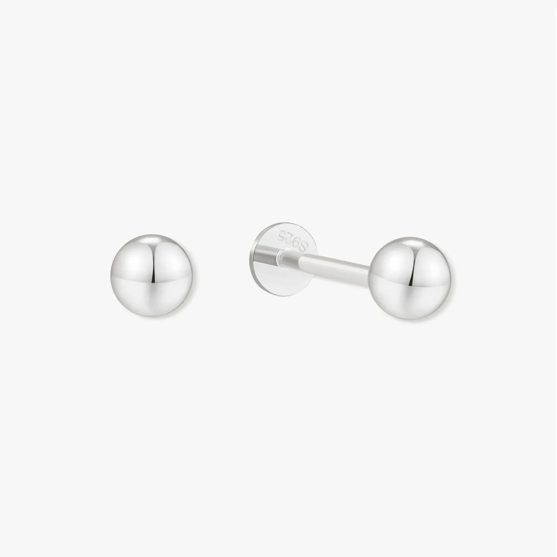 Pair of silver stud earrings on a white background