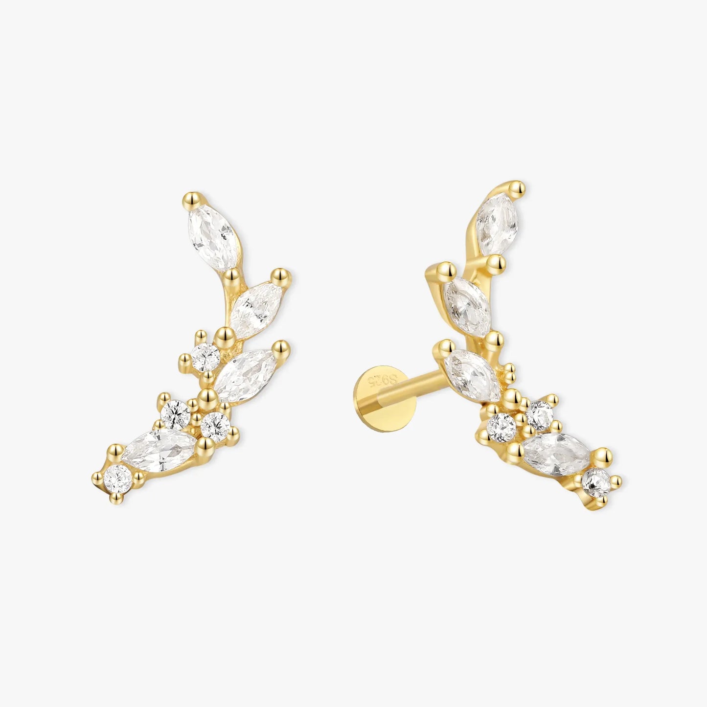 Gold earrings with clear gemstones on a white background