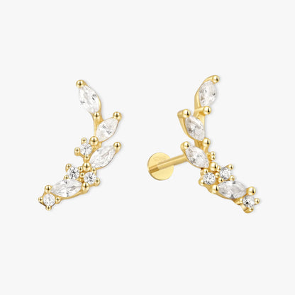 Gold earrings with clear gemstones on a white background
