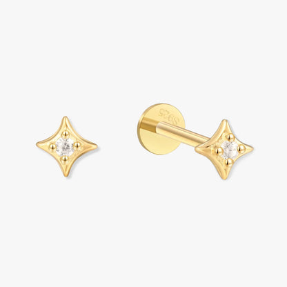 Gold star-shaped earrings with clear gemstones on a white background
