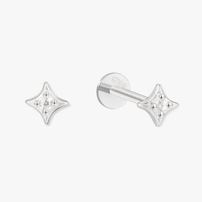Star-shaped silver earrings on a white background
