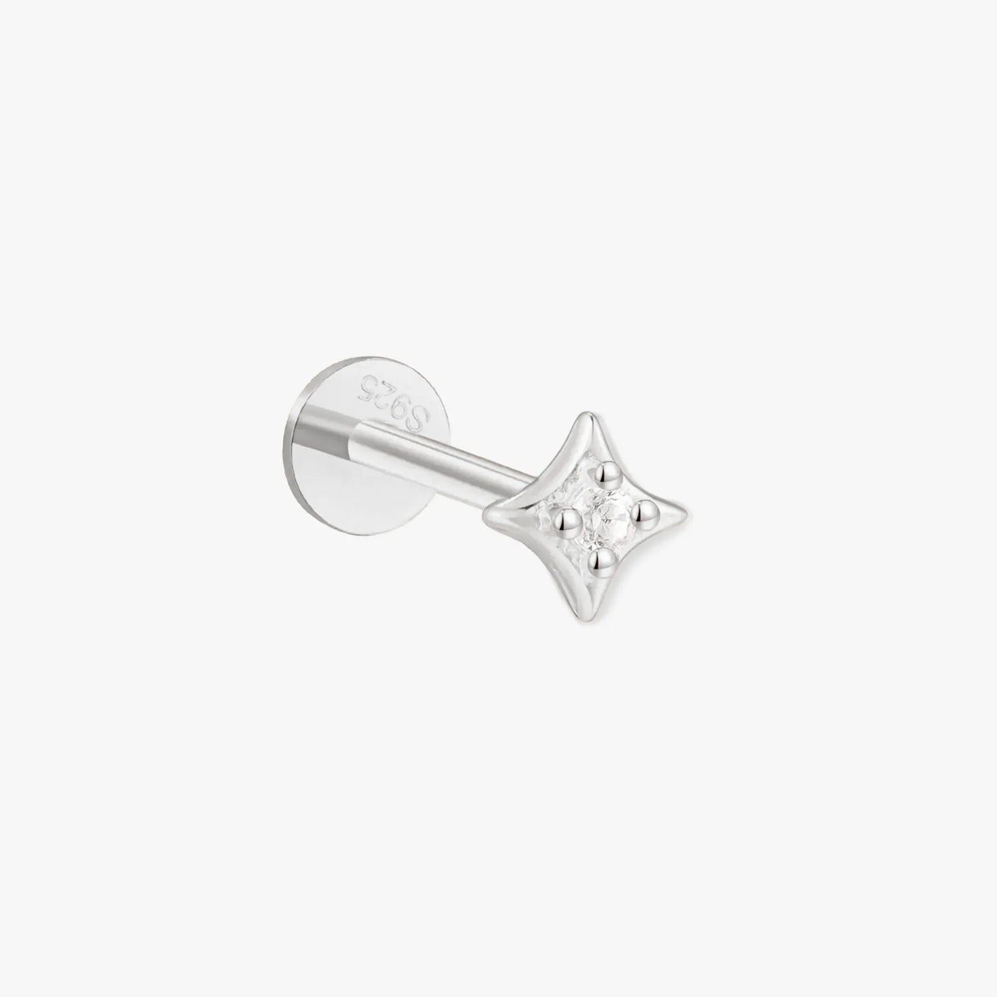 Silver star-shaped earring on a white background
