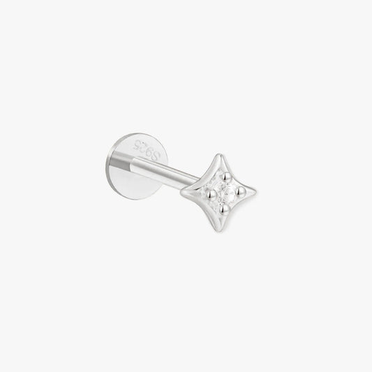 Silver star-shaped earring on a white background