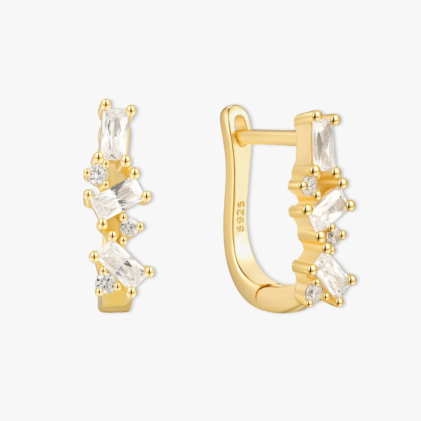 Gold hoop earrings with clear gemstones on a white background