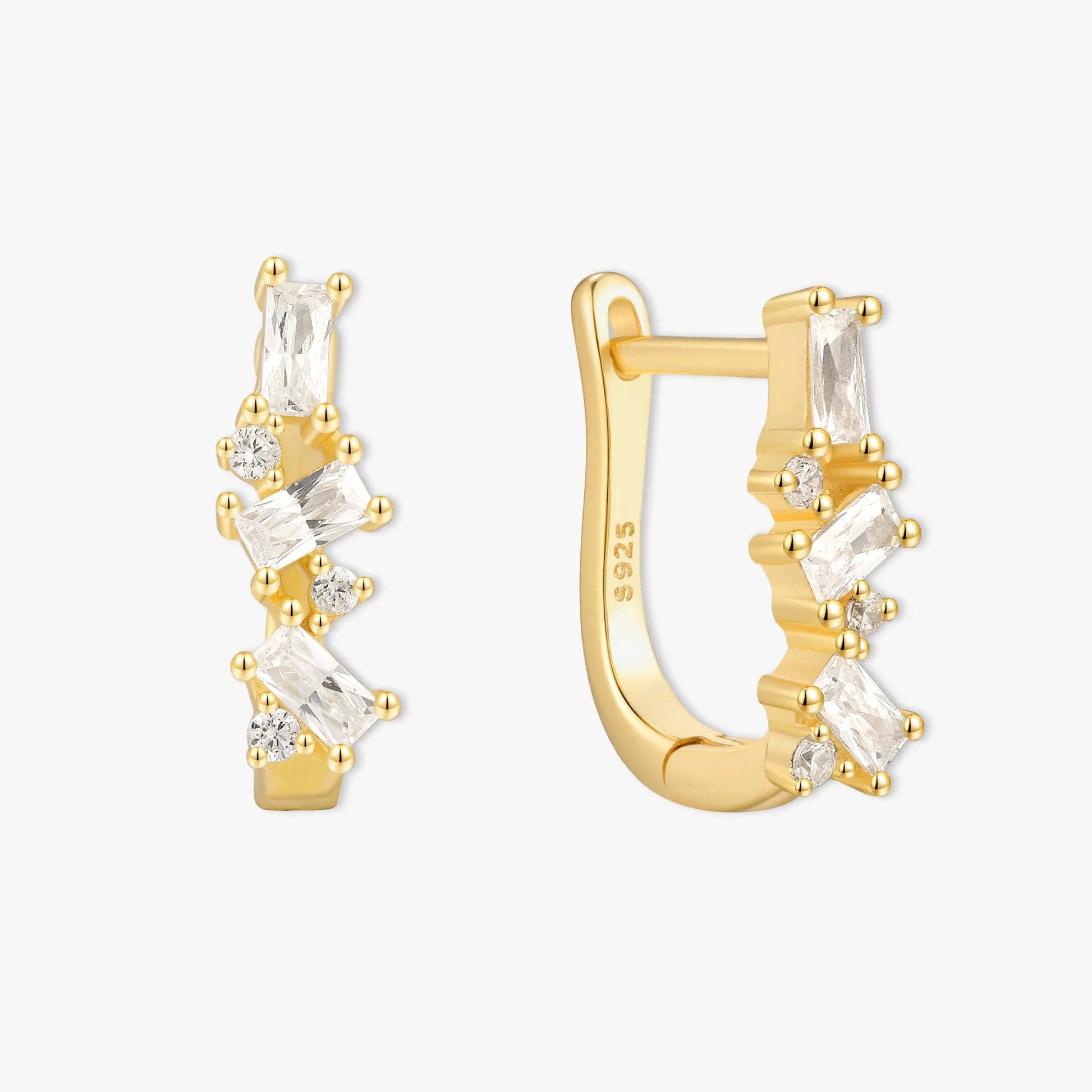 Gold hoop earrings with clear gemstones on a white background