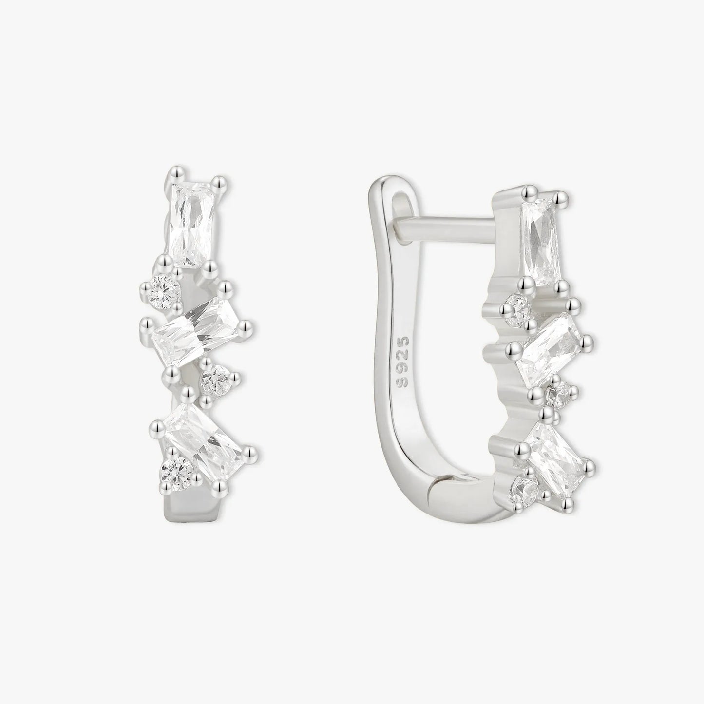 Silver hoop earrings with clear gemstones on a white background