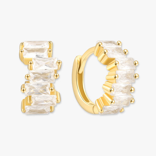 Gold hoop earrings with clear gemstones on a white background