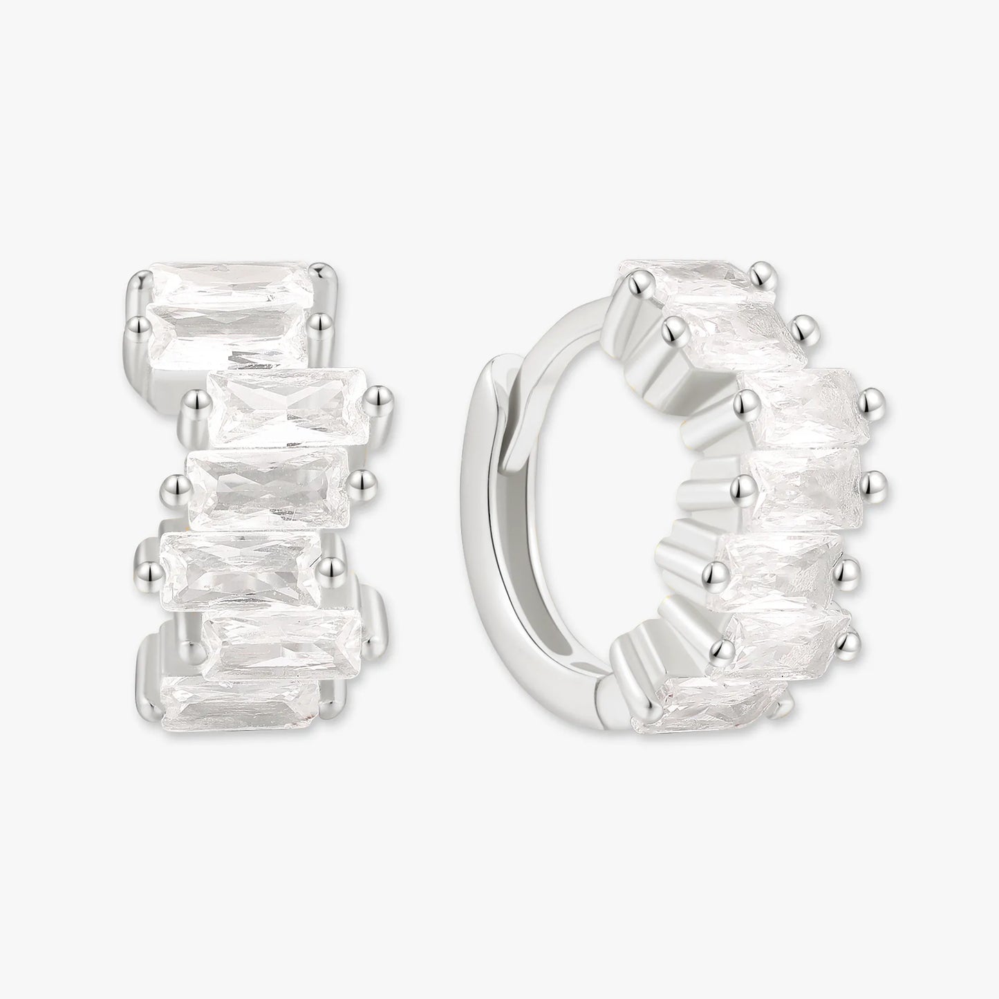 Silver hoop earrings with clear gemstones on a white background